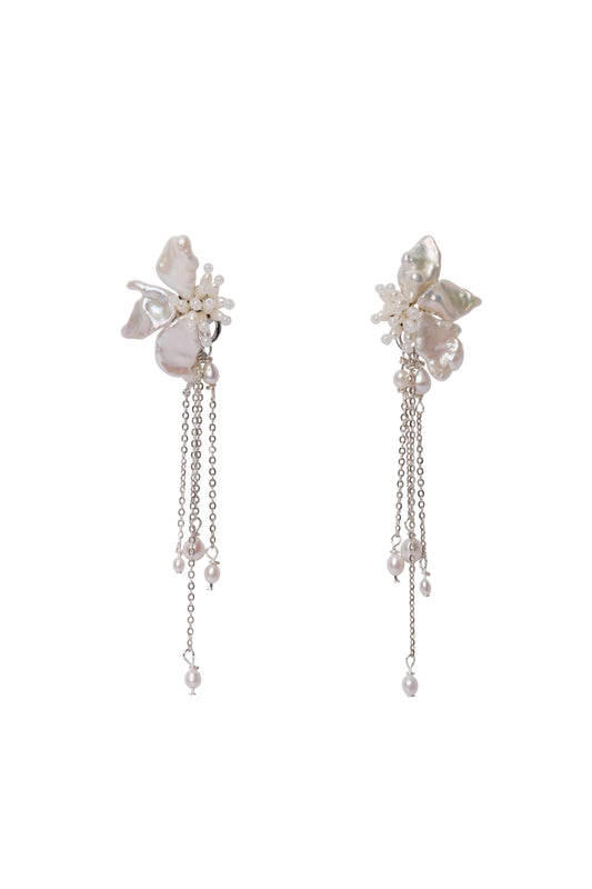 Pair of floral earrings with chain details on a white background