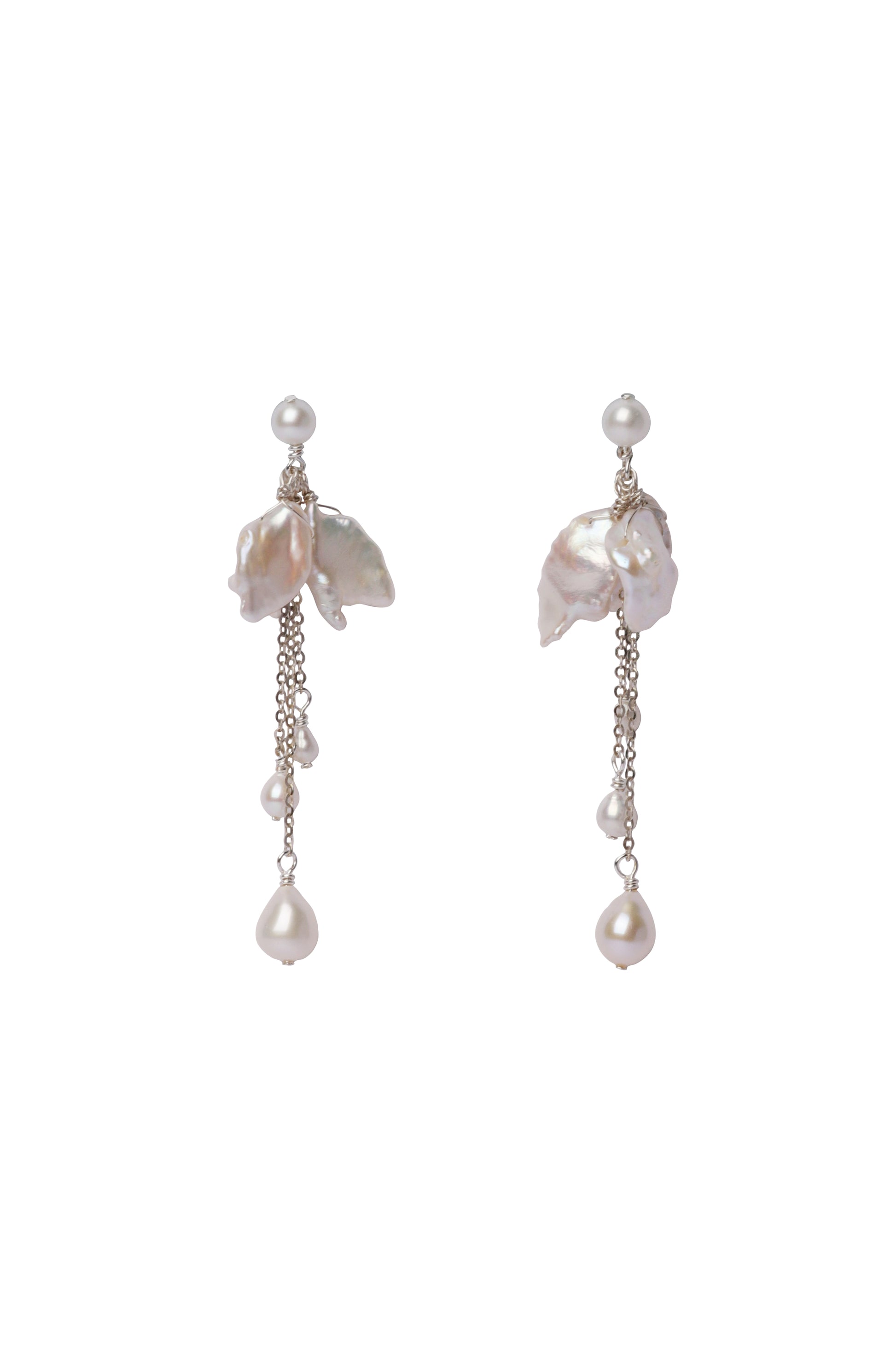 Pair of pearl earrings with dangling chains on a white background