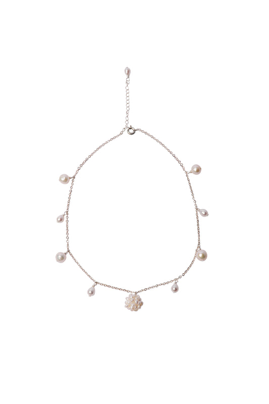 Necklace with pearls and a woven pearl flower pendant on a white background